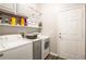 Functional laundry room featuring modern appliances, overhead cabinets, and ample storage space at 5416 Oxford Manor Cir, Lakeland, FL 33810
