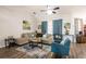 Bright living room with a cozy beige sectional, vibrant blue accents, and modern ceiling fan at 5416 Oxford Manor Cir, Lakeland, FL 33810