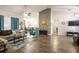 Open-concept living space with comfortable seating, modern decor, and laminate wood flooring at 5416 Oxford Manor Cir, Lakeland, FL 33810