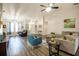 Bright open-concept living room with wood flooring, a comfortable seating arrangement, and natural light at 5416 Oxford Manor Cir, Lakeland, FL 33810