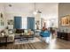 Bright, open living room featuring modern furnishings, neutral walls, and wood laminate flooring at 5416 Oxford Manor Cir, Lakeland, FL 33810