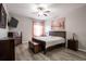 Cozy main bedroom with neutral walls, wood-look floors, and decorative accents at 5416 Oxford Manor Cir, Lakeland, FL 33810
