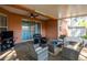 Screened in patio with ceiling fan, TV and comfortable seating at 5416 Oxford Manor Cir, Lakeland, FL 33810