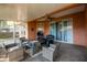 Enclosed patio with brick flooring, plenty of seating, and ceiling fan at 5416 Oxford Manor Cir, Lakeland, FL 33810