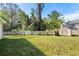 A large, fenced backyard features lush green grass, mature trees, and a storage shed at 638 Coral Way, Winter Springs, FL 32708