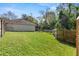 Spacious fenced backyard featuring lush green grass and views of the home's exterior at 638 Coral Way, Winter Springs, FL 32708