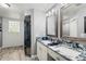 Bathroom with walk-in shower and double vanity with granite countertops at 638 Coral Way, Winter Springs, FL 32708