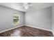A well-lit bedroom features stylish wood floors, neutral walls, and a modern ceiling fan at 638 Coral Way, Winter Springs, FL 32708