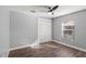A well-lit bedroom features stylish wood floors, neutral walls, a closet, and a modern ceiling fan at 638 Coral Way, Winter Springs, FL 32708