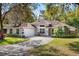 Charming single-story home with attached garage, well-manicured lawn, and mature trees at 638 Coral Way, Winter Springs, FL 32708