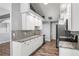 Kitchen featuring white cabinets, granite counters and stainless steel appliances at 638 Coral Way, Winter Springs, FL 32708