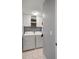 A clean and organized laundry room includes a washer, dryer, and white storage cabinets at 638 Coral Way, Winter Springs, FL 32708