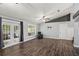 Generously sized living room featuring wood floors, ceiling fans, and access to the patio at 638 Coral Way, Winter Springs, FL 32708
