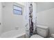 Small bathroom featuring a white bathtub, toilet, and a playful patterned shower curtain, optimizing space at 4305 Hamilton Rd, Lakeland, FL 33811