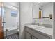 Bright bathroom with a white vanity, sink, toilet, and tiled shower for a clean and functional space at 4305 Hamilton Rd, Lakeland, FL 33811
