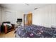 Comfortable bedroom with white paneling, wood-look flooring, and a cozy armchair for lounging at 4305 Hamilton Rd, Lakeland, FL 33811