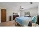 Bedroom featuring wood-look flooring, a ceiling fan, neutral paint, and natural light from large windows at 4305 Hamilton Rd, Lakeland, FL 33811