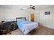 Bedroom featuring wood-look flooring, a ceiling fan, closet, and a blue bedspread for a relaxing vibe at 4305 Hamilton Rd, Lakeland, FL 33811