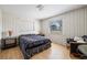 Cozy bedroom featuring wood-look flooring, neutral paint, and furnishings, offering a relaxed ambiance at 4305 Hamilton Rd, Lakeland, FL 33811