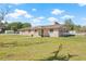 Quaint brick home featuring a well-kept lawn and mature landscaping at 4305 Hamilton Rd, Lakeland, FL 33811