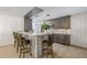 Kitchen features a bar area with seating, mosaic tile backsplash and stainless steel appliances at 4305 Hamilton Rd, Lakeland, FL 33811