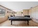 Large living area featuring wood paneled walls, laminate flooring, and a pool table at 4305 Hamilton Rd, Lakeland, FL 33811