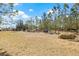 Open property with hay bales ready for farm animals and multiple buildings in the background at 4305 Hamilton Rd, Lakeland, FL 33811