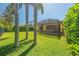 Picturesque backyard with a screened lanai, mature trees, and lush green grass, ideal for outdoor enjoyment at 8427 Prestbury Dr, Orlando, FL 32832