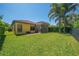 Expansive backyard showcasing a well-manicured lawn, privacy fence, and mature palm trees, perfect for entertaining at 8427 Prestbury Dr, Orlando, FL 32832