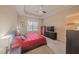 A neutral-toned bedroom with a ceiling fan, window, and modern furniture for a calming retreat at 8427 Prestbury Dr, Orlando, FL 32832