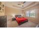 Bedroom with a ceiling fan, bright window, and a cozy bed at 8427 Prestbury Dr, Orlando, FL 32832