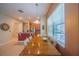 Inviting dining area adjacent to the kitchen, featuring a window with natural light and a modern pendant light at 8427 Prestbury Dr, Orlando, FL 32832