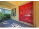Elegant red double front door with brick pavers, offering a warm welcome to visitors at 8427 Prestbury Dr, Orlando, FL 32832