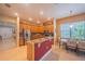 Open kitchen with stainless steel appliances, granite countertops, and a breakfast bar adjacent to an eat-in dining area at 8427 Prestbury Dr, Orlando, FL 32832