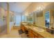 Spacious main bathroom with double vanity sinks, granite countertops, separate bathtub, and a glass-enclosed shower at 8427 Prestbury Dr, Orlando, FL 32832