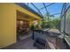 Enclosed patio featuring a hot tub, seating area and ceiling fan at 8427 Prestbury Dr, Orlando, FL 32832