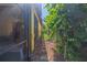 Property side yard view showcasing a pathway, lush greenery, and gate access to enhance outdoor living at 8427 Prestbury Dr, Orlando, FL 32832