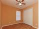 Cozy bedroom with wood floors, closet, ceiling fan, and a window that filters soft light at 316 Boca Ciega Rd, Mascotte, FL 34753