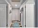 Bright hallway with modern flooring, white doors, and decorative wall art, providing a welcoming transition at 161 W Christina Blvd, Lakeland, FL 33813