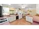 Bright kitchen with view into dining room, featuring laminate countertops, and plenty of cabinet space at 604 Ellsworth Way, The Villages, FL 32162