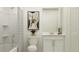 Bathroom featuring a toilet, tub with shower, vanity, and modern artwork at 1157 Hour Glass Rd, Lakeland, FL 33801