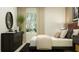 Bedroom featuring a black dresser, a neutral-toned bed, and a plant at 1157 Hour Glass Rd, Lakeland, FL 33801