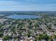 Expansive aerial view of the neighborhood with mature trees and a lake in the background at 501 15Th Ne Ct, Winter Haven, FL 33881