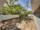 Large backyard featuring a white fence line for added privacy and well-established trees at 501 15Th Ne Ct, Winter Haven, FL 33881