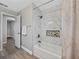 Bathtub with marble tile surround and decorative shelving nook at 501 15Th Ne Ct, Winter Haven, FL 33881