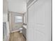 Bright bathroom featuring modern fixtures, gray vanity, wood-look floors, and closet at 501 15Th Ne Ct, Winter Haven, FL 33881