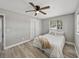 Bedroom with wood-look floors, ceiling fan and double closet at 501 15Th Ne Ct, Winter Haven, FL 33881