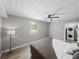 Bedroom with ceiling fan, wood-look floors, and laundry access at 501 15Th Ne Ct, Winter Haven, FL 33881