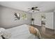 Bedroom with ensuite bath, ceiling fan, neutral walls and wood-look floors at 501 15Th Ne Ct, Winter Haven, FL 33881