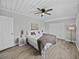 Bedroom with ceiling fan, neutral walls, wood-look flooring and closet at 501 15Th Ne Ct, Winter Haven, FL 33881